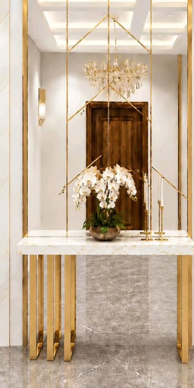 Entrance foyer with brass-framed mirror and marble console