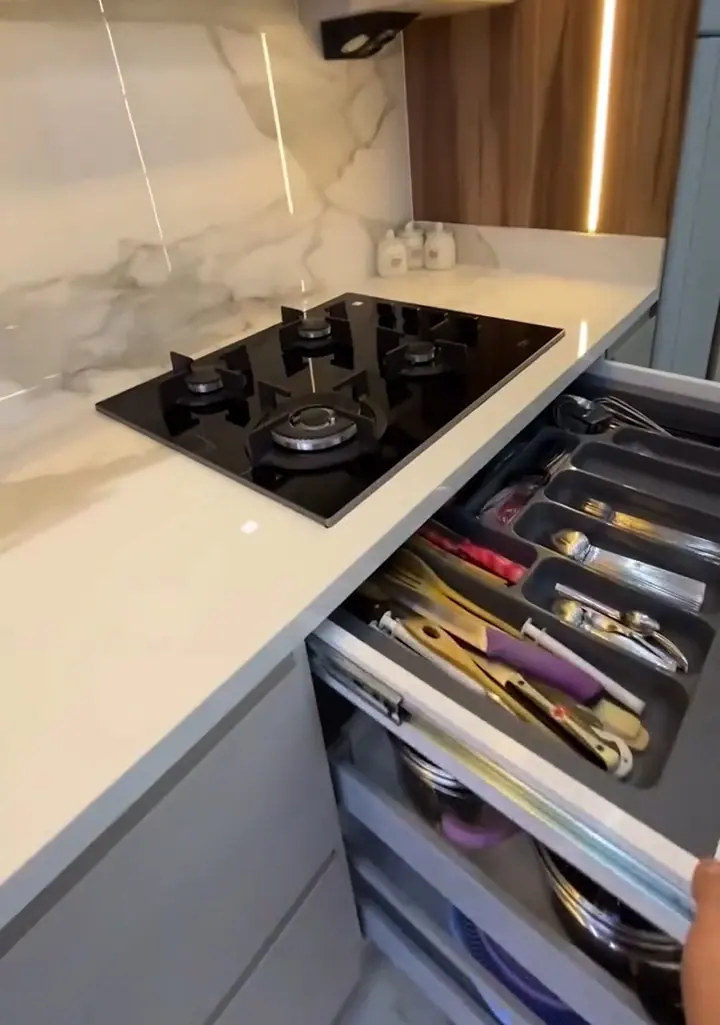 Modern modular kitchen with marble backsplash and organised drawers
