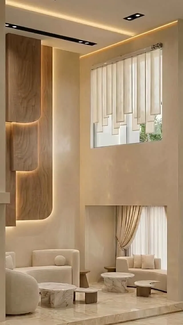 Double-height living room finished in lime plaster with warm cove lighting